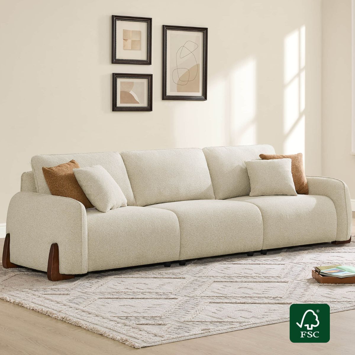 Cream 3-seat modular curved sofa with dark wood legs and accent pillows, on a patterned rug with an FSC logo.
