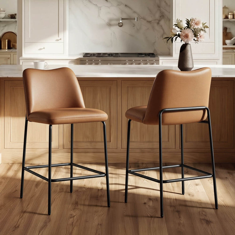 Two tan leather-look Amalia barstools with black metal bases in a modern kitchen