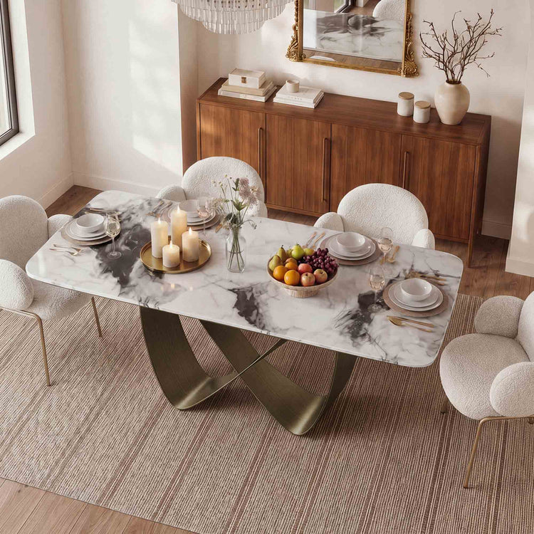 Dining room with a marble table set for a meal, featuring chairs and a sideboard.