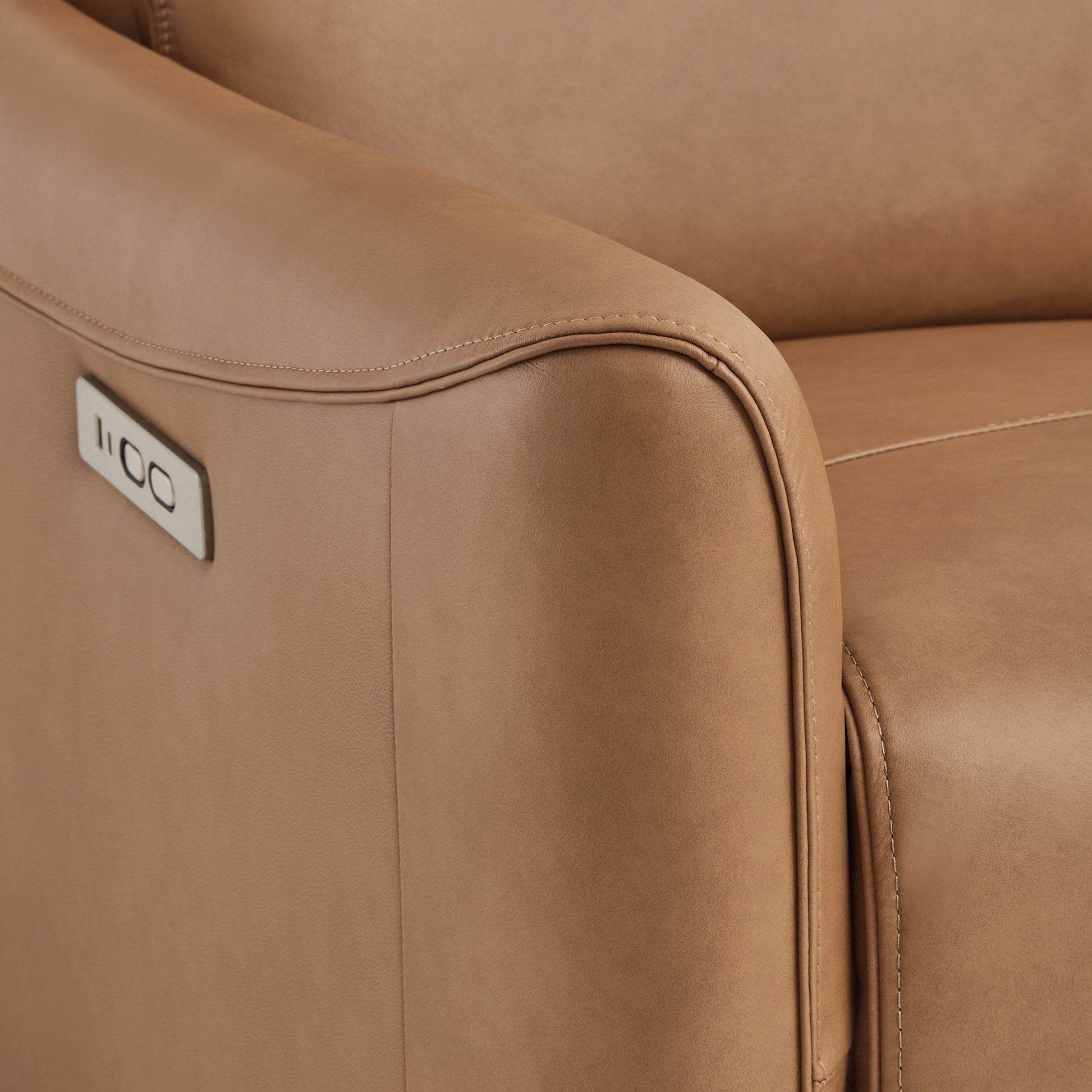 Close-up of Tracee brown power swivel recliner's sleek arm and USB port - CHITA Living