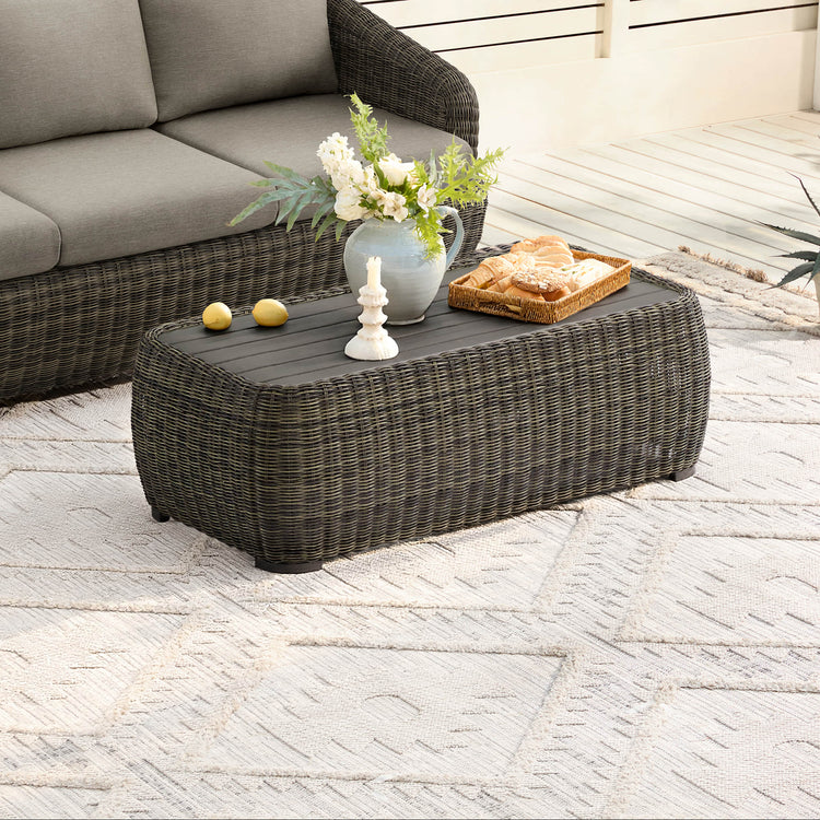 Liana Wicker Outdoor Coffee Table with dark woven base and wood grain top