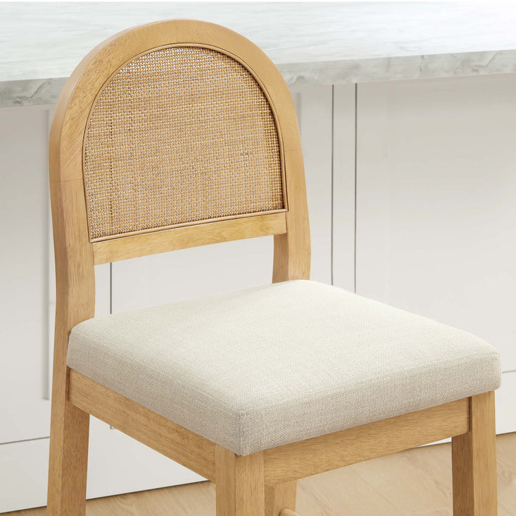 Abigail Rattan Curved Counter Stool features a woven backrest and cushioned seat, blending modern design with natural materials.