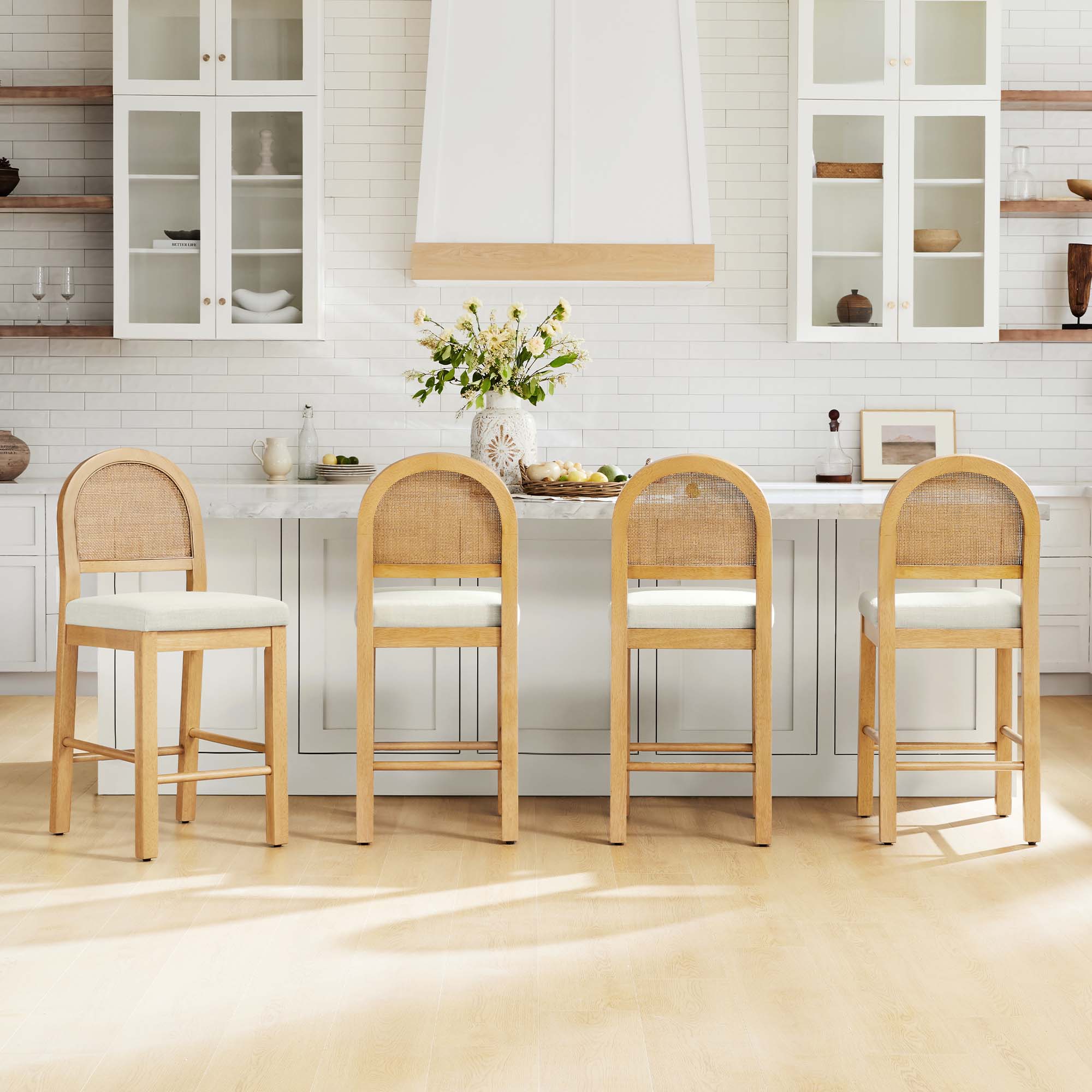Abigail Rattan Curved Counter Stools with Performance Fabric feature woven backs and cushioned seats, arranged in a modern kitchen.