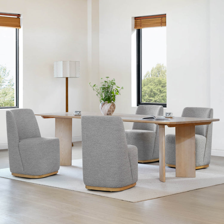 Gray textured wingback chairs surrounding a light wooden dining table in a bright room - CHITA Living