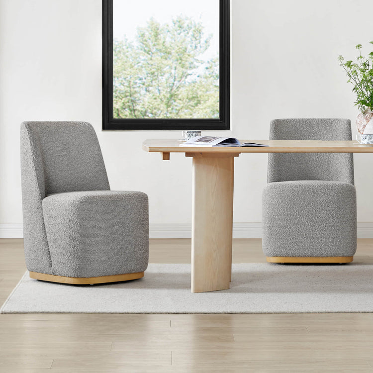 Modern gray upholstered wingback chairs with curved wooden base at a sleek dining table - CHITA Living