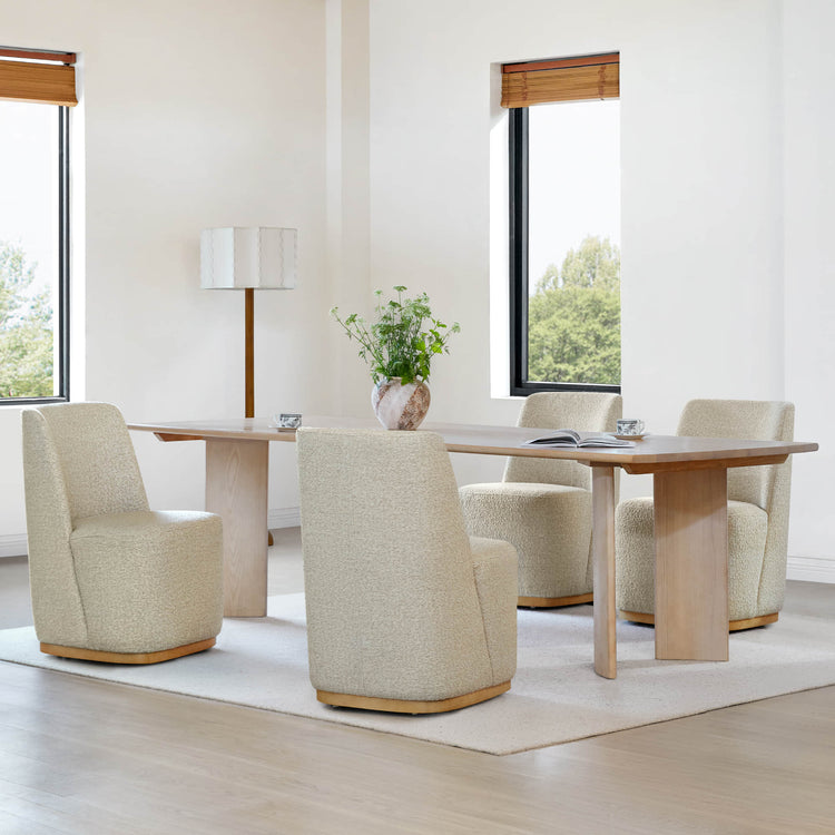 Beige textured wingback chairs around a light wooden dining table in a bright room - CHITA Living