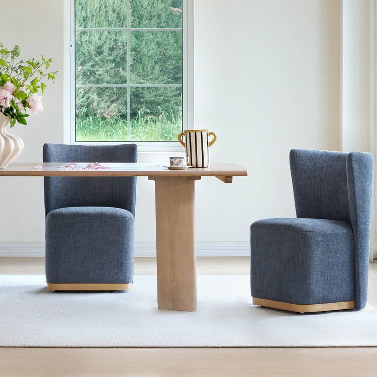 Blue wingback dining chairs with curved design at light wooden table in modern dining room - CHITA Living