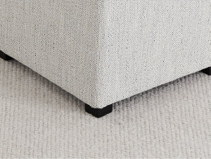 Textured white cube ottoman with black feet on a cream rug - CHITA Living