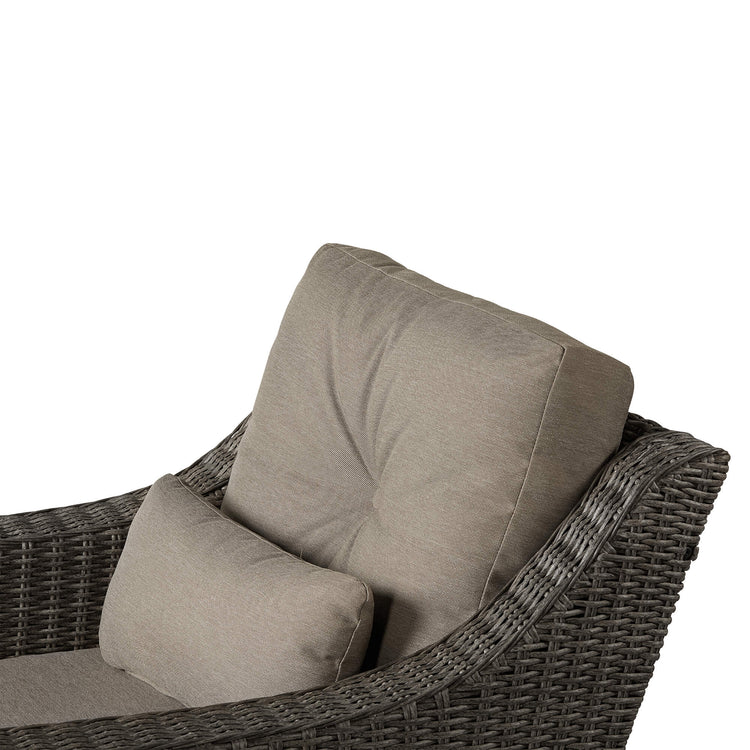 Close-up of gray rattan lounge chair with plush beige cushions for outdoor comfort - CHITA Living