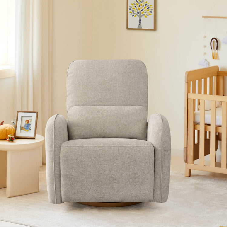 The Power Swivel Nursery Glider Recliner sits in a serene nursery, featuring a neutral fabric and rounded armrests.