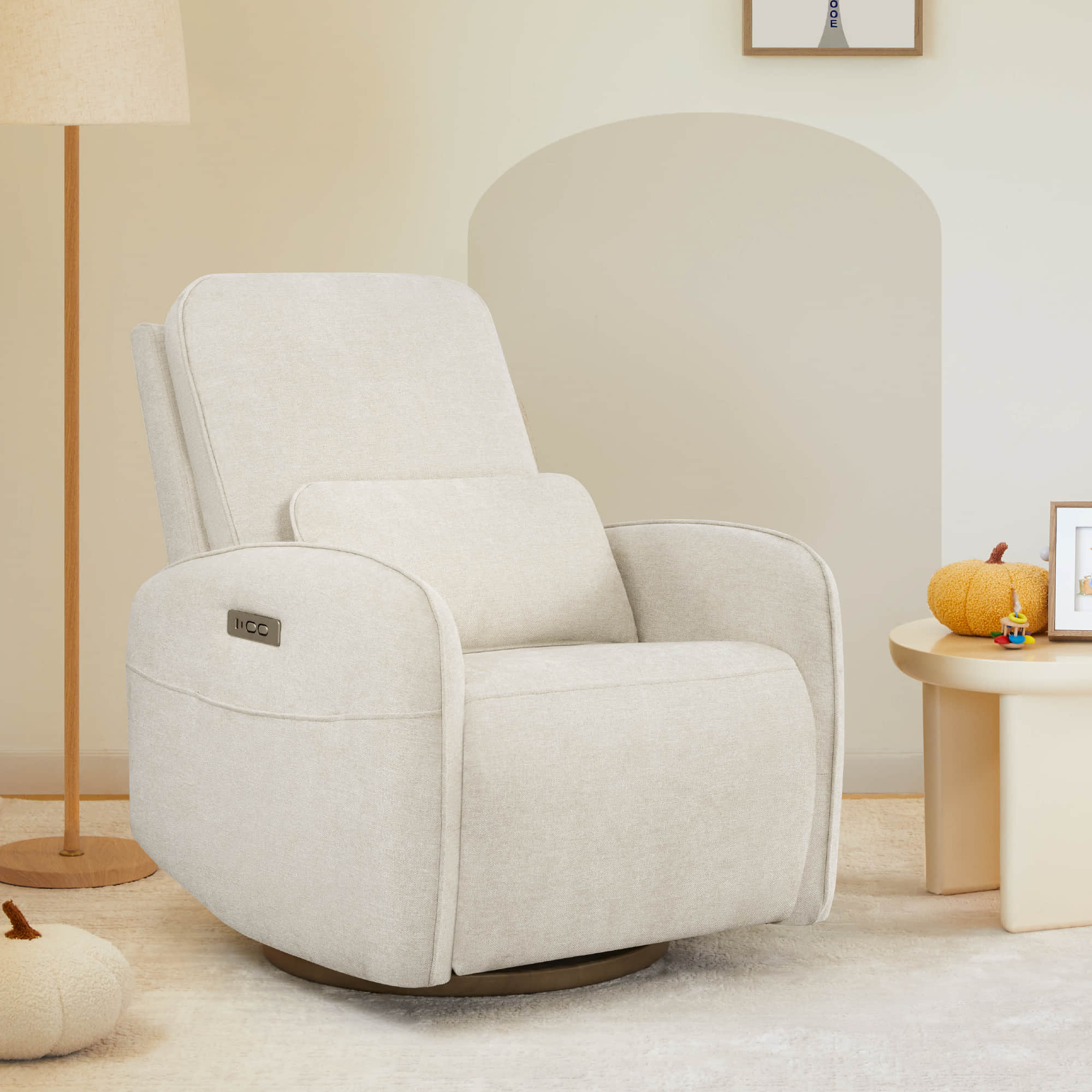 The Power Swivel Nursery Glider Recliner, in soft beige fabric, offers a cozy spot for relaxation.