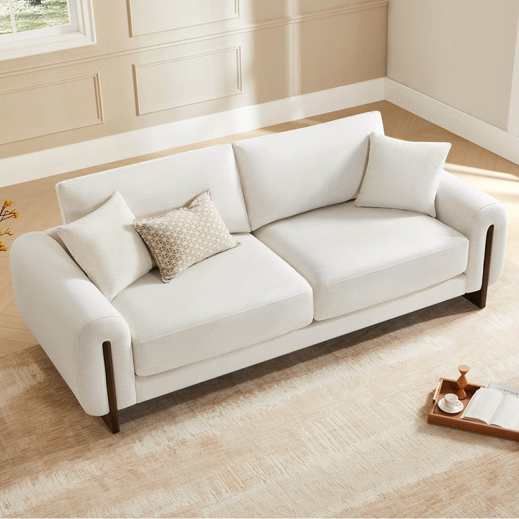 Modern white furniture sofa, top-down view with throw pillows.