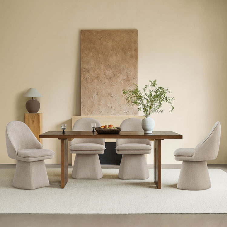 Modern dining room with beige swivel chairs, wooden table, and elegant decor.