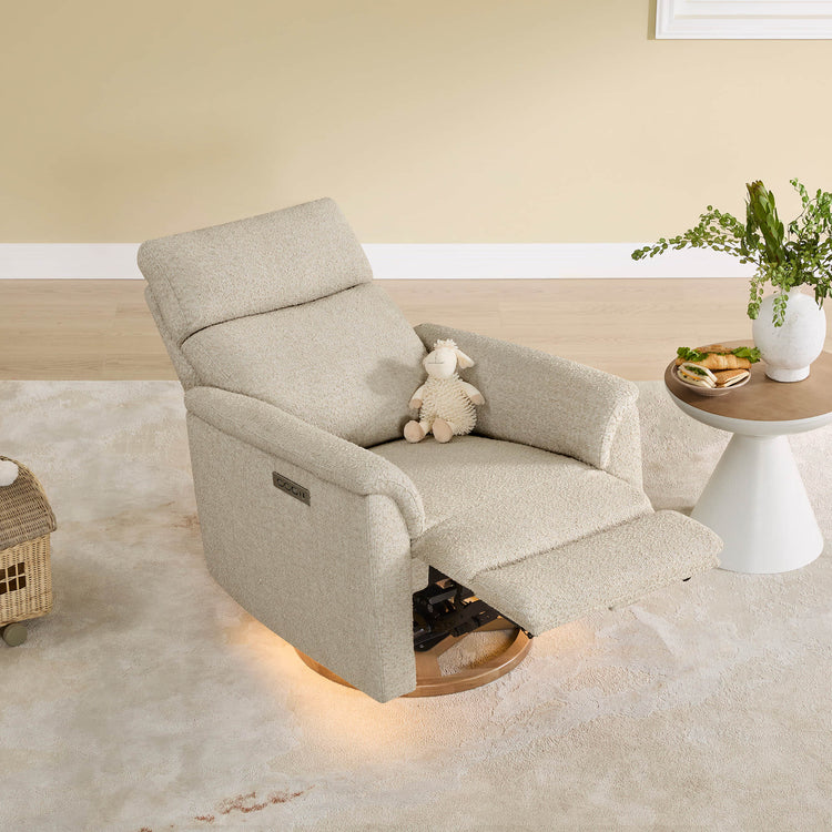 Cream Lulla nursery glider recliner with power headrest, USB ports, and nightlight in a nursery setting.