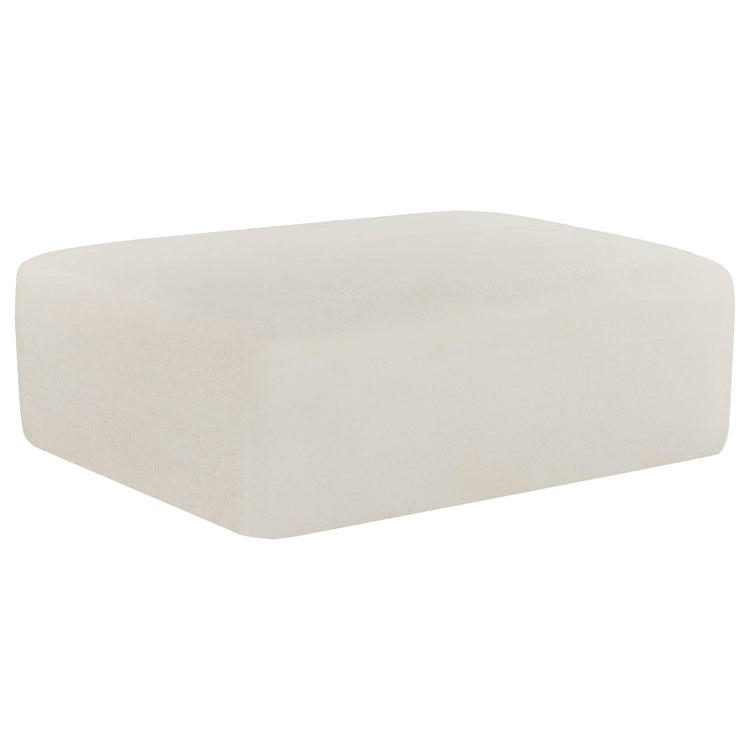 The Winsley 3-Seat Sofa Ottoman is a sleek, off-white rectangular piece with a soft, plush texture.