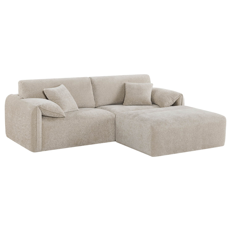 The Winsley 3-Seat Sofa with Ottoman features a cozy beige fabric, plush cushions, and a modern L-shaped design.