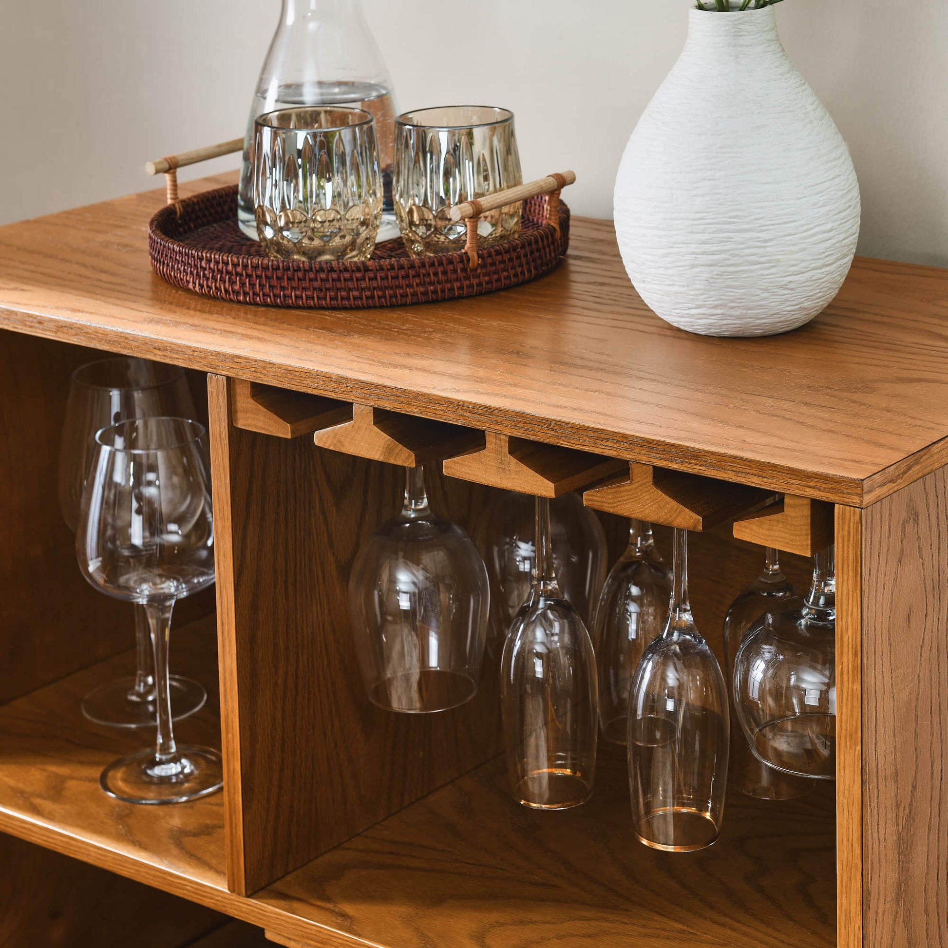 Mid-century modern oak wine cabinet with glass holder and wine rack, stylish storage for home bar.