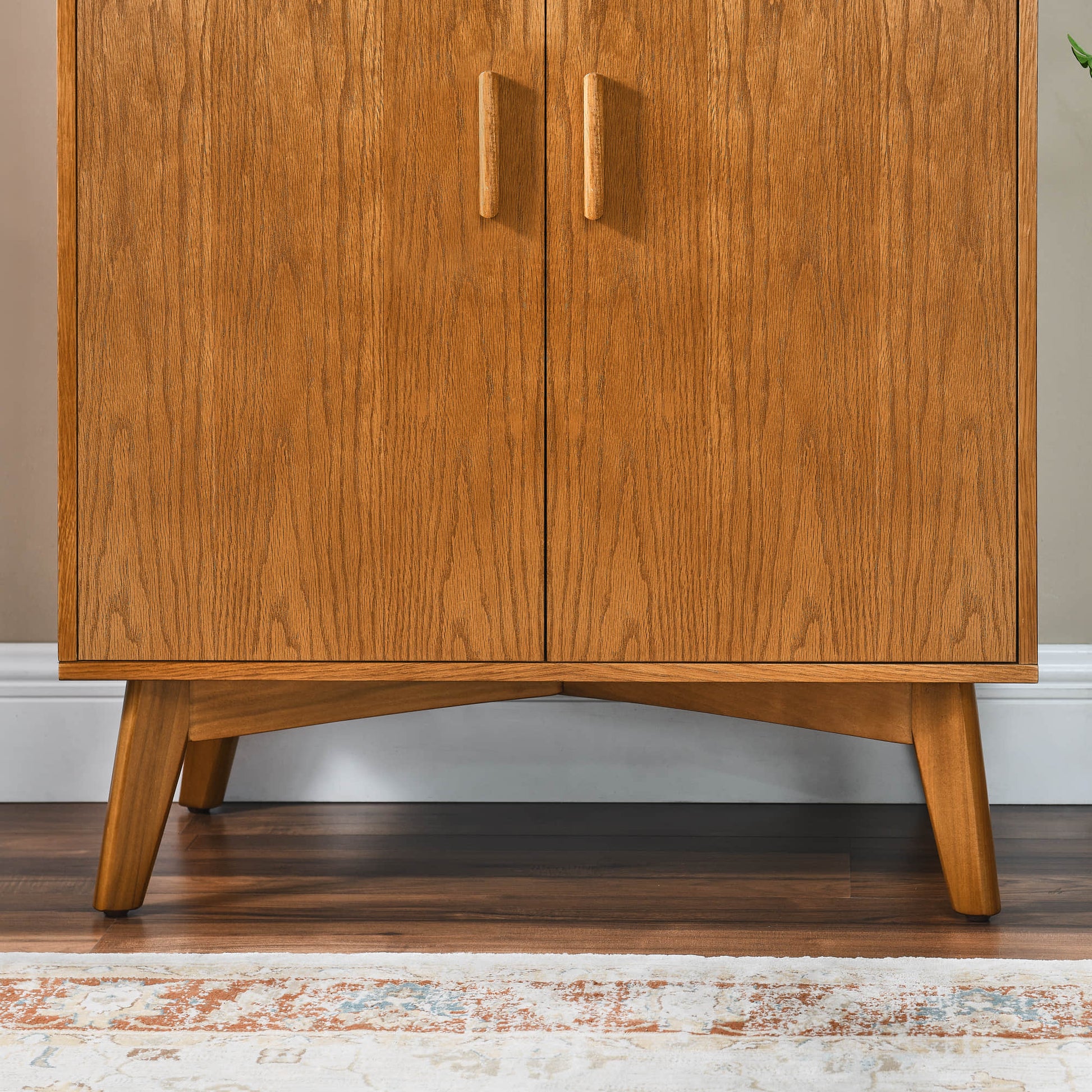 Mid-century oak wine cabinet, featuring wooden cabinet doors, solid wood legs, and stylish storage for home bar.