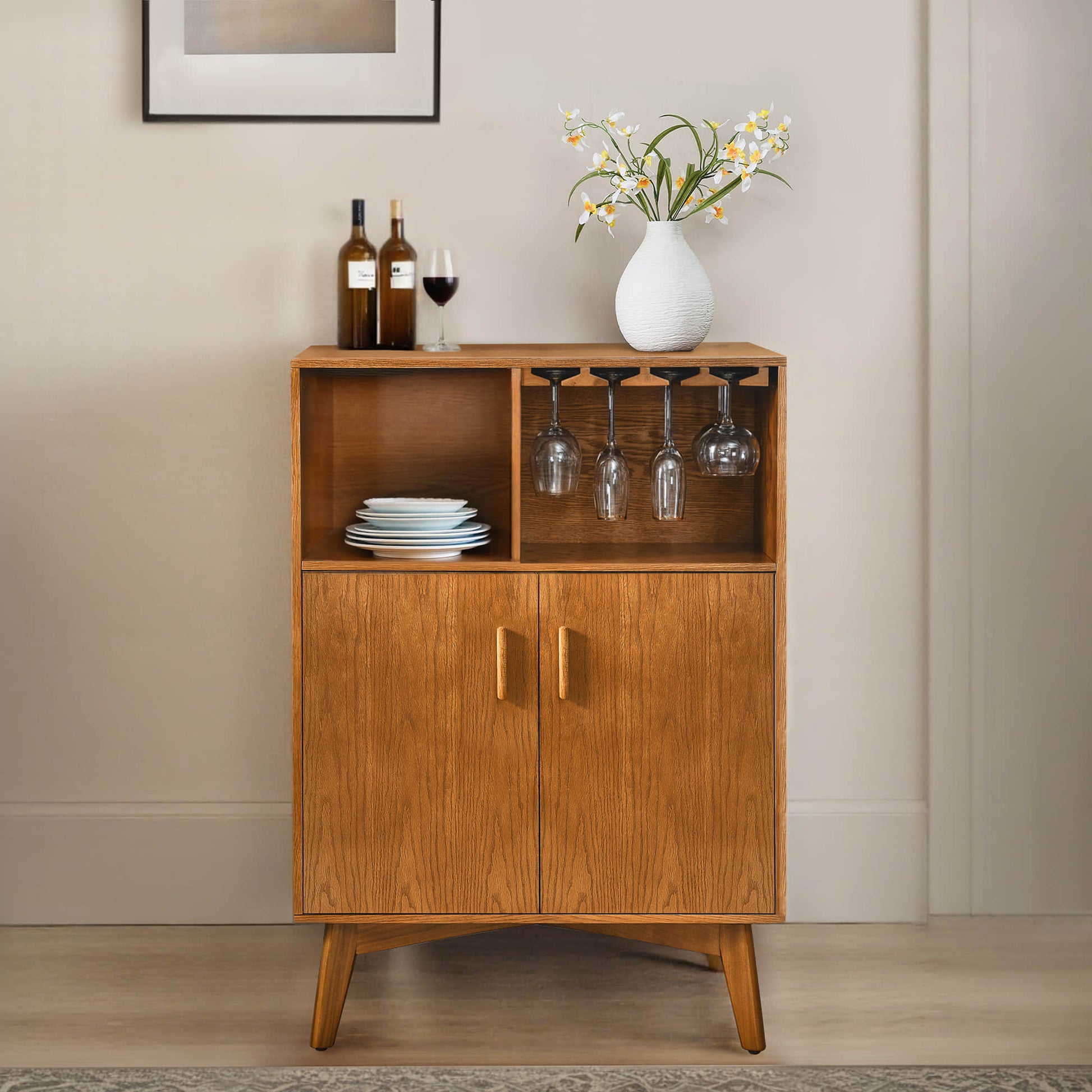 Mid-century wine cabinet with wine glass holder and wine rack. Oak wood cabinet with glasses, wine bottles, and plates.