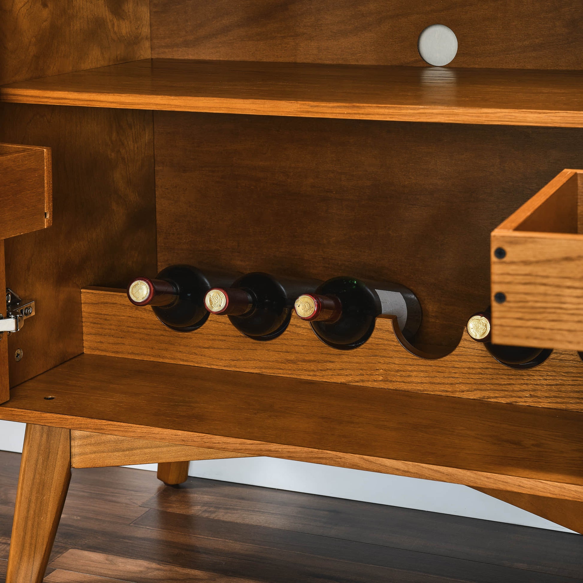 Mid-century modern wine cabinet interior with wine bottle storage and adjustable shelf. Oak wood veneer detail.