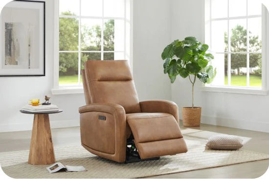 A brown leather recliner in a bright room with a large window