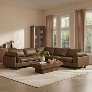 Brown leather U-shaped sectional with dual chaises in a neutral living room