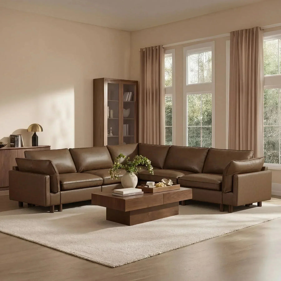Brown leather U-shaped sectional with dual chaises in a neutral living room