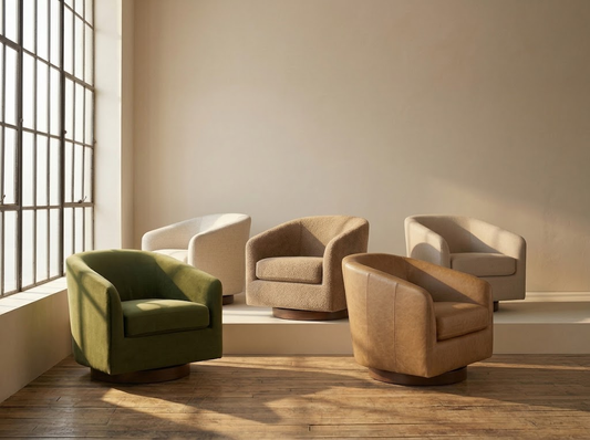 Five barrel-back swivel accent chairs in green velvet, cream boucle, white textured fabric, brown boucle, and tan leather, arranged on a wood floor in a sunlit minimalist room with large windows.