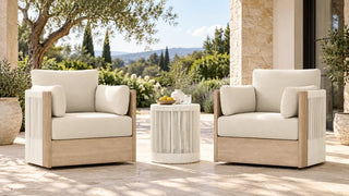 Clover acacia-frame woven outdoor chairs and a matching round table on a covered terrace.