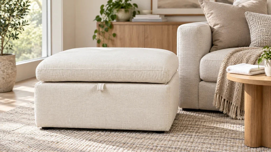 Ivory Delaney storage ottoman beside a neutral sofa in a bright living room.