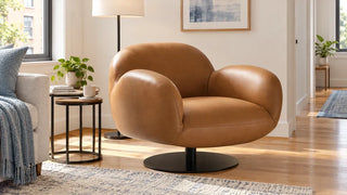 Brown Cloud Puffy swivel chair beside nesting tables in a compact apartment living area.