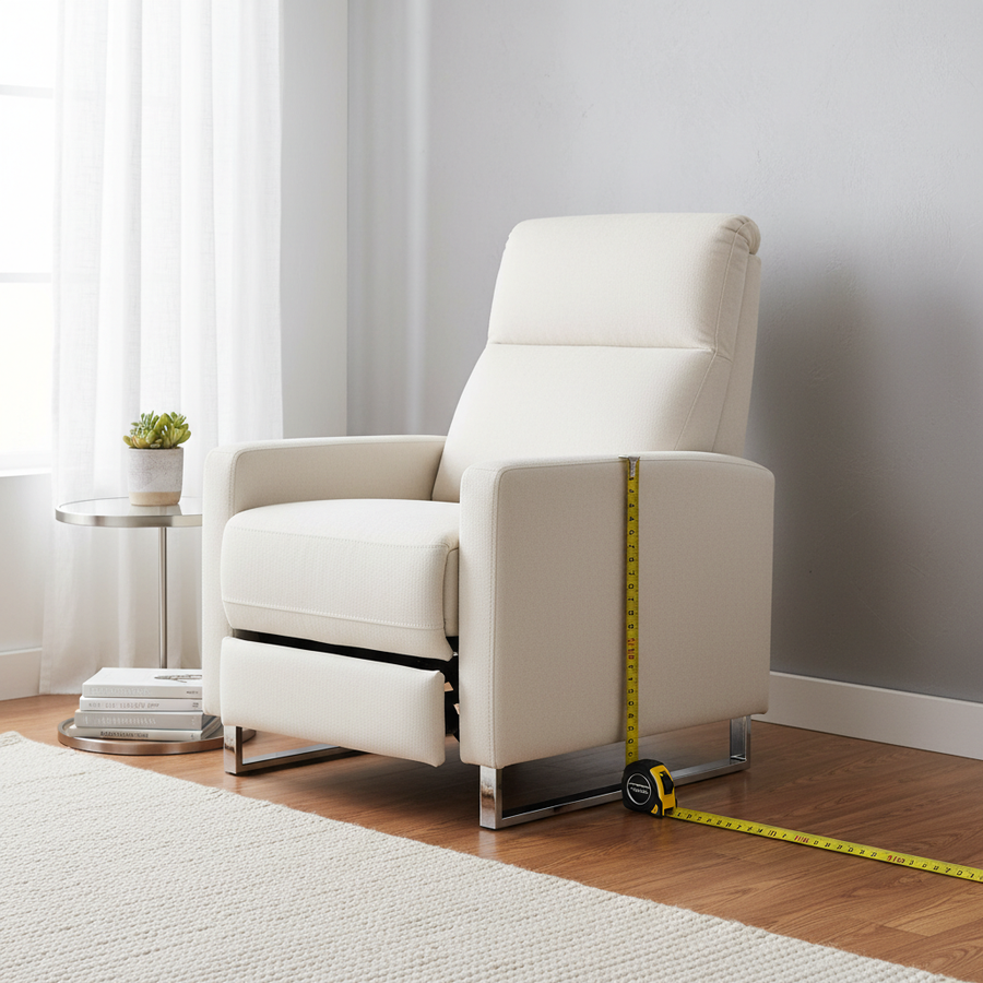 A sleek modern wall-hugger recliner positioned just 4 inches from a wall in a bright, small apartment living room with a measuring tape on the floor.