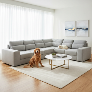 A luxurious modern living room featuring a pet-friendly modular power sectional sofa in light gray performance fabric, with a happy Golden Retriever and a cat resting nearby in a clean, sunlit space.