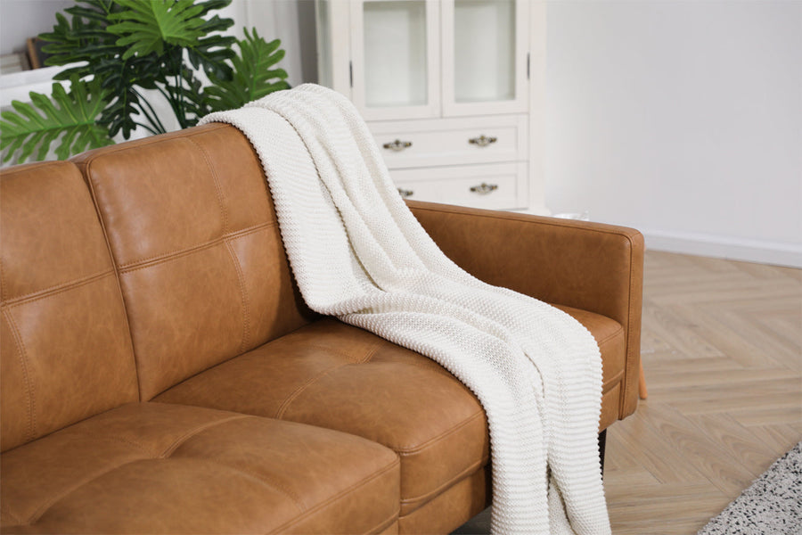 Brown sofa with a white knit throw shows easy upholstery care inspiration for maintaining clean sofa cushions, smooth fabric surfaces, and cozy living room style