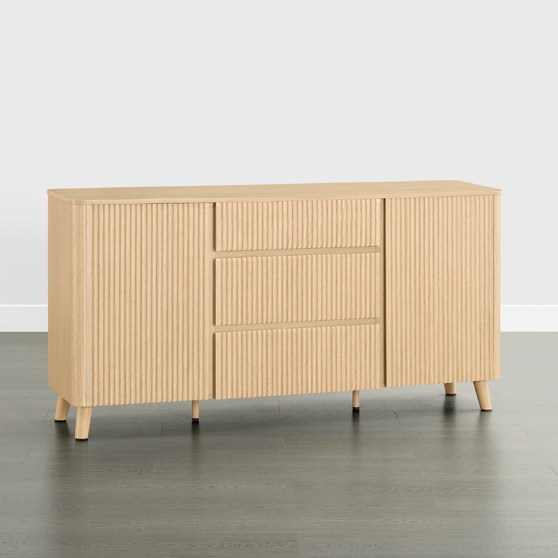 62" Clara Contemporary Wood Sideboard - 62" Clara Contemporary Wood Sideboard in Natural Oak with fluted doors and three drawers, featuring tapered wood legs.