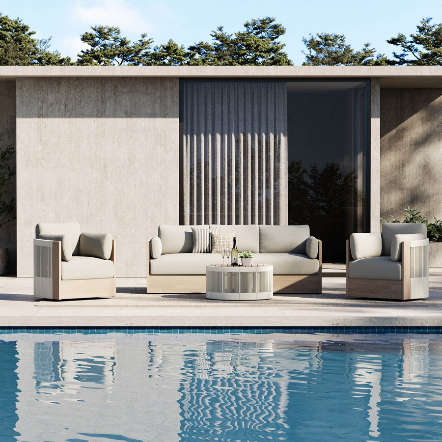 Editorial hero showing a complete outdoor furniture arrangement for poolside lounging.