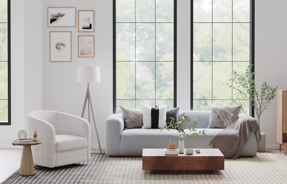 Tall black-framed windows and wall art suggest open-plan room sightlines, highlighting why sofa placement mistakes can disrupt natural light and visual flow in living spaces