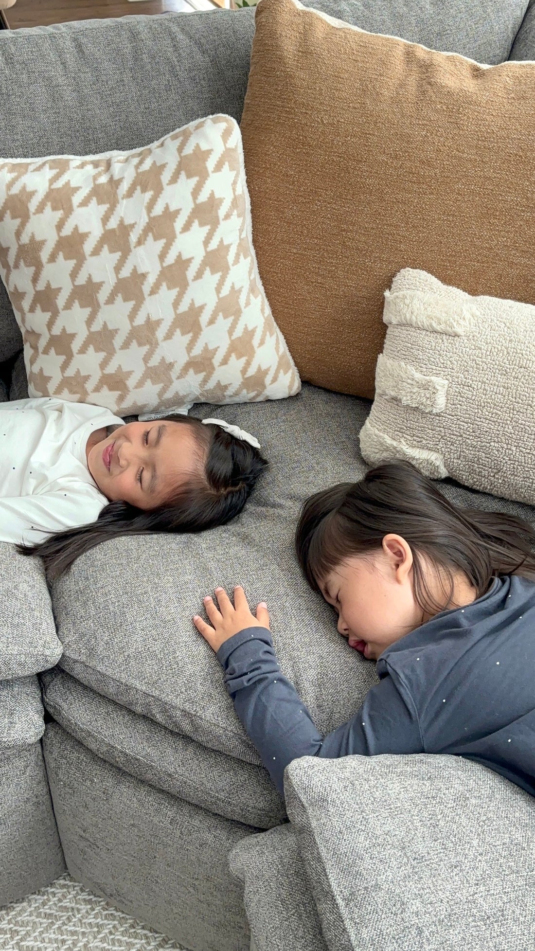 Family members relaxing on modular sofa with houndstooth pillows creating perfect family bonding moment for Family Day.