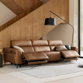 Brown leather reclining sofa with chaise and black floor lamp in a wood-paneled modern living room.