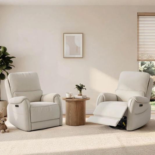Two cream power recliners sit beside a small wooden table in a bright neutral bedroom-style space, with one chair fully upright and the other extended.