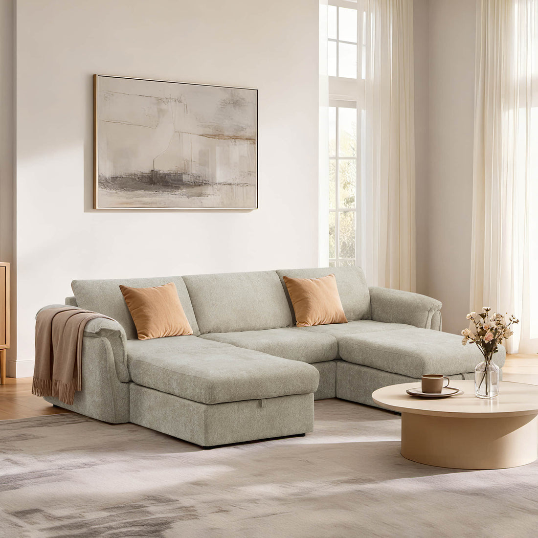 Light gray sectional sofa with orange pillows in a bright, modern living room.
