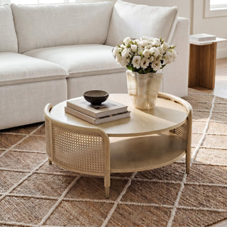 A broad room view showing how a round coffee table can anchor a curved seating arrangement while preserving circulation.