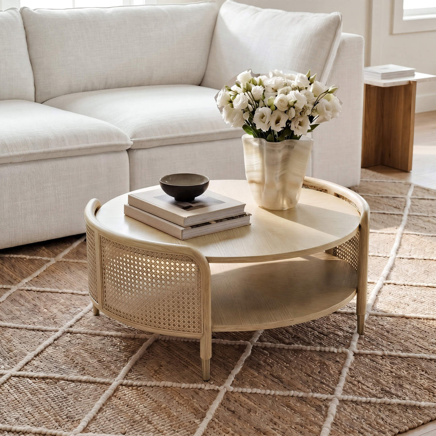 A broad room view showing how a round coffee table can anchor a curved seating arrangement while preserving circulation.