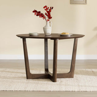 A round four-person dining table provides a visual contrast to the compact two-person bistro-table footprint discussed in the article.