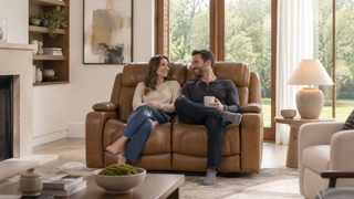 Brown reclining sofa with a couple lounging