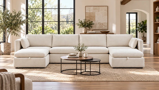 Cream Delaney modular sectional with two ottomans in an open living room.