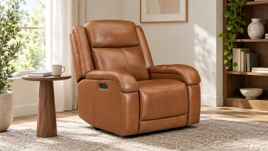 Brown Isaac leather recliner beside a reading table in a sunlit room
