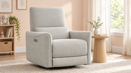 Light-gray Tracee glider recliner beside a wood table in a nursery reading corner.