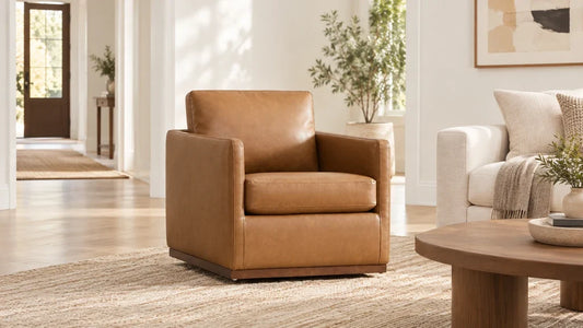Tan Henry accent chair beside an ivory sofa and an open living room entrance