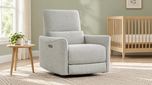 Light-gray Tracee recliner beside a wooden crib in a sage nursery